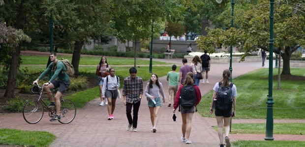 Students walk to and from classes on the Indiana University campus. Thursday, Oct. 14, 2021, in Bloomington, Ind. 