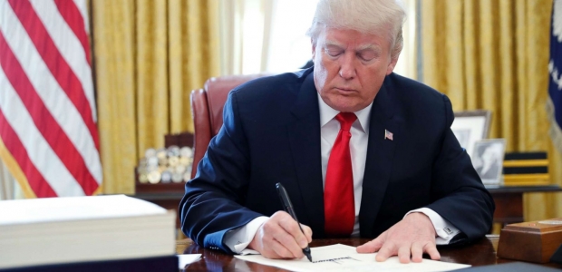 then-president donald trump signing the tax cuts and jobs act of 2017 into law