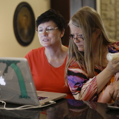 Mother with baby looking at laptop